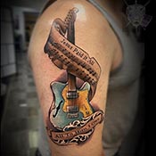 Jesus Paid it all on colorful guitar tattoo