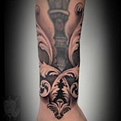 abstract lines of faces tattoo on shoulder