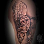 Fern leaves on wrist in black and grey tattoo