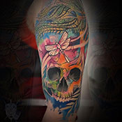 Black and grey scizzors over flower tattoo