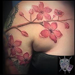 flower on branch in pink covering top arm and shoulder